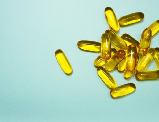 capsule vitamins to boost metabolism on blue background