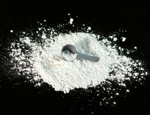 creatine hydrochloride powder on black background